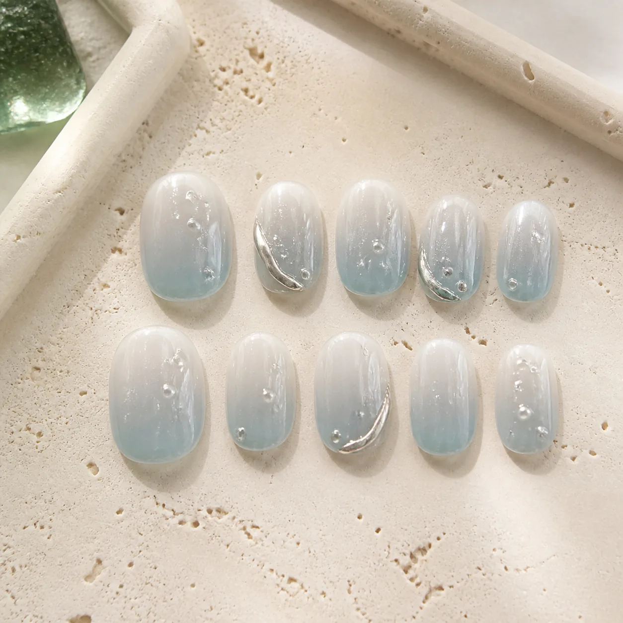 Translucent blue Mirelle nail set with silver details